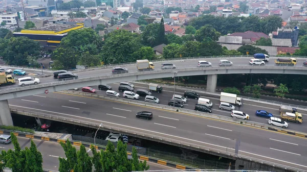 Road system. Road interchanges. Multi-level highways. The movement of vehicles on highways in different directions. View of multi-level roads from a height.
