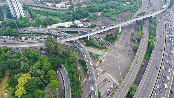 Road system. Road interchanges. Multi-level highways. The movement of vehicles on highways in different directions. View of multi-level roads from a height.