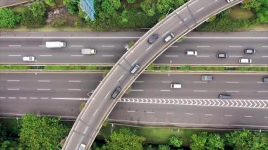 both ways traffic passing by fly over and Tomang Interchange in Jakarta. Top Down Aerial bird eye View.Zoom out.