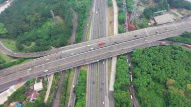 both ways traffic passing by fly over and Tomang Interchange in Jakarta. Top Down Aerial bird eye View. static position.