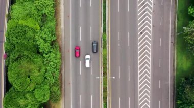Top down view of rush hour on the road with cars moving slowly during traffic jam.
