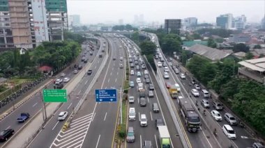 Aerial view of vehicles passing through underpass road near Tanah Abang market in Jakarta city. Shot in 4k resolution from a drone flying forwards.