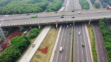 Bird Eye view with slider moton above high way of Jakarta with fast moving traffic. Aerial Drone shot.