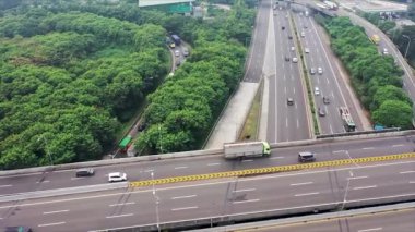 Aerial view of vehicles passing through underpass road near Tanah Abang market in Jakarta city. Shot in 4k resolution from a drone flying forwards.