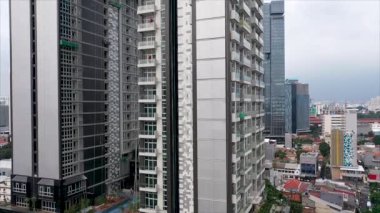 Moving up to the clouds along windows Office building and high rise modern skyscraper. Construction of high-rise building with many floors. Building is a place of work for trade and business center.