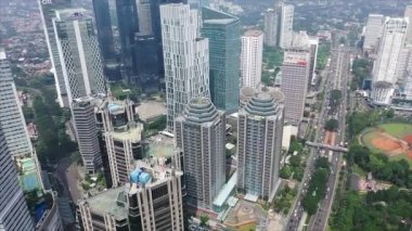JAKARTA, Indonesia, May 20, 2022. Beautiful aerial view of modern office buildings on misty morning in Jakarta city. Shot in 4k resolution from a drone.