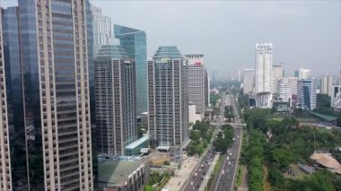 JAKARTA, Indonesia, May 20, 2022. Beautiful aerial view of modern office buildings on misty morning in Jakarta city. Shot in 4k resolution from a drone.