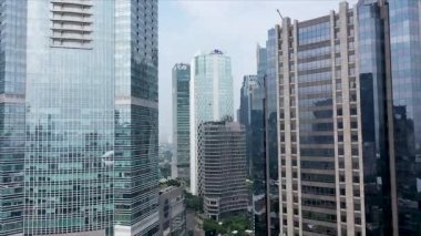 JAKARTA - Indonesia. May 20, 2022: Flying between Glass skyscrapers in downtown area of a Modern city.