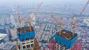 Aerial view of construction site. People working. Top view of new apartment under construction. Picture made by drone from above.