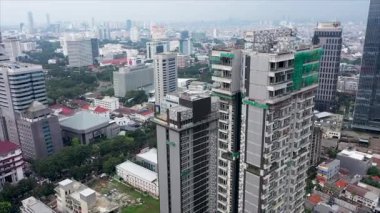 Beautiful aerial view of Jakarta city with skyscrapers and light rail transit track construction. Shot in 4k resolution.