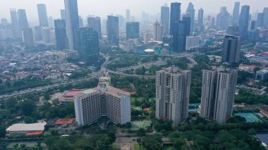 Aerial View of Jakarta Downtown Skyline with High-Rise Buildings at Noon.