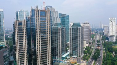 Aerial view of Jakartas Central Business District at early morning. Sunlight falls on the building.