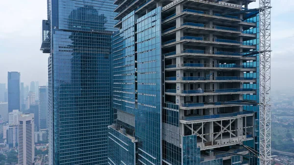 Building a high-rise building, view of a skyscraper under construction - the concept of real estate construction.