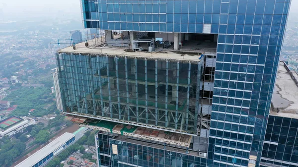 Building a high-rise building, view of a skyscraper under construction - the concept of real estate construction.