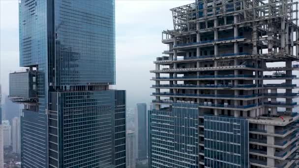 空中飞行飞越高塔起重机大楼的新建筑开发场地 起重机在有摩天大楼的建筑工地上工作 建造一座多层公寓楼 — 图库视频影像