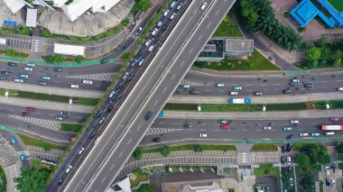 Aerial top down view on massive multi-level interchange on Jakarta city on a sunny summer day with light traffic.