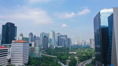 Aerial View of Jakarta Downtown Skyline with High-Rise Buildings at Noon.