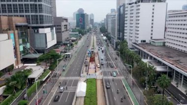 sunny day jakarta city downtown traffic street road aerial panorama 4k indonesia.