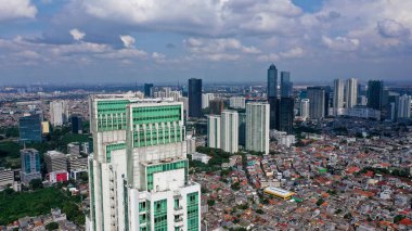Aerial Jakarta view from above Sudirman street in the morning with building and rush hours view.