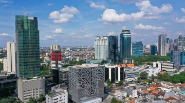 Aerial Jakarta view from above Sudirman street in the morning with building and rush hours view.