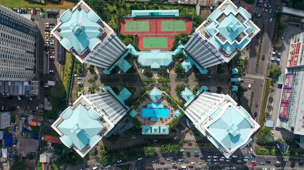 Top down view building of a residential complex in Jakarta city. The complex consists of four condominium buildings.