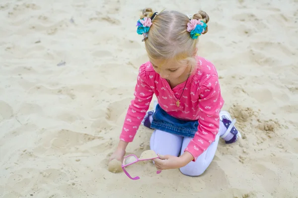 Fem-årig flicka spelar på en strand — Stockfoto