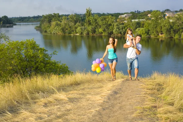 Young happy family outdoor — Stock Photo, Image