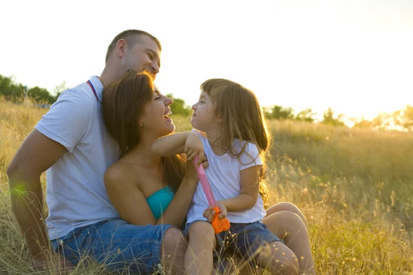 Beautiful young family of three — Stock Photo, Image