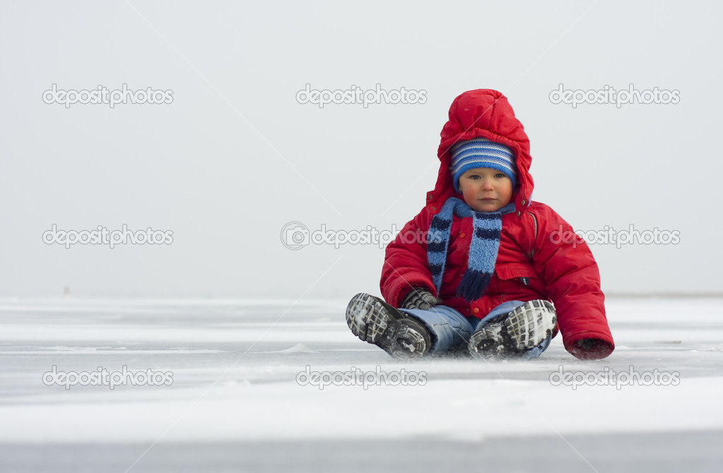 Little boy in winter on ice