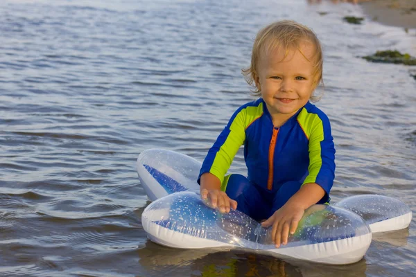 Pequeño niño juega cerca del agua — Foto de Stock