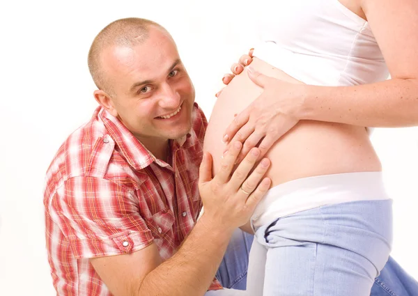 Man embracing a stomach of the pregnant spouse — Stock Photo, Image