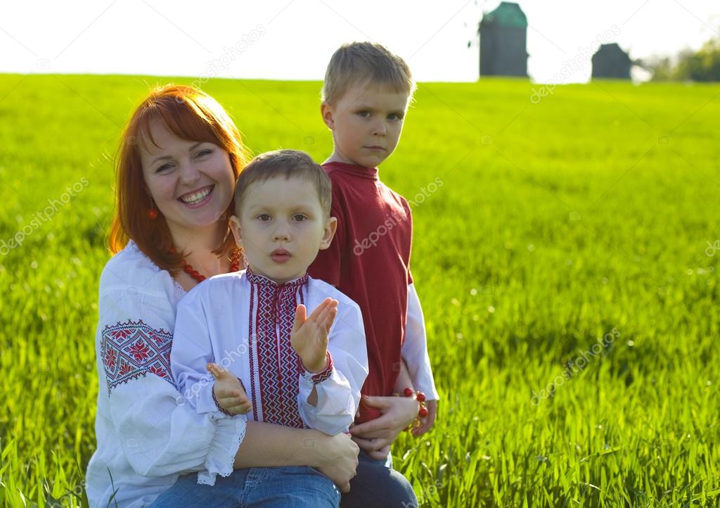 Happy mother with two sons outdoors