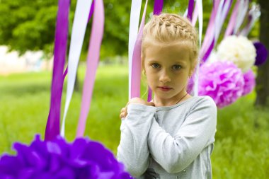 Portrait of a beautiful girl of five years in the summer park clipart