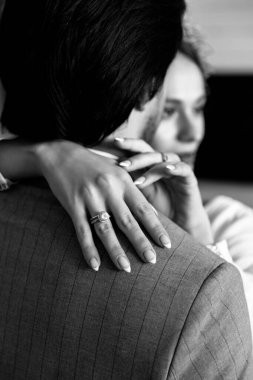 Black and white photo of happy young couple in love hugging each other