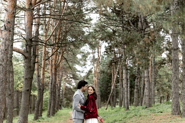 Beautiful Young Wedding Couple Hugging Walking Pine Forest High Quality — Stockfoto