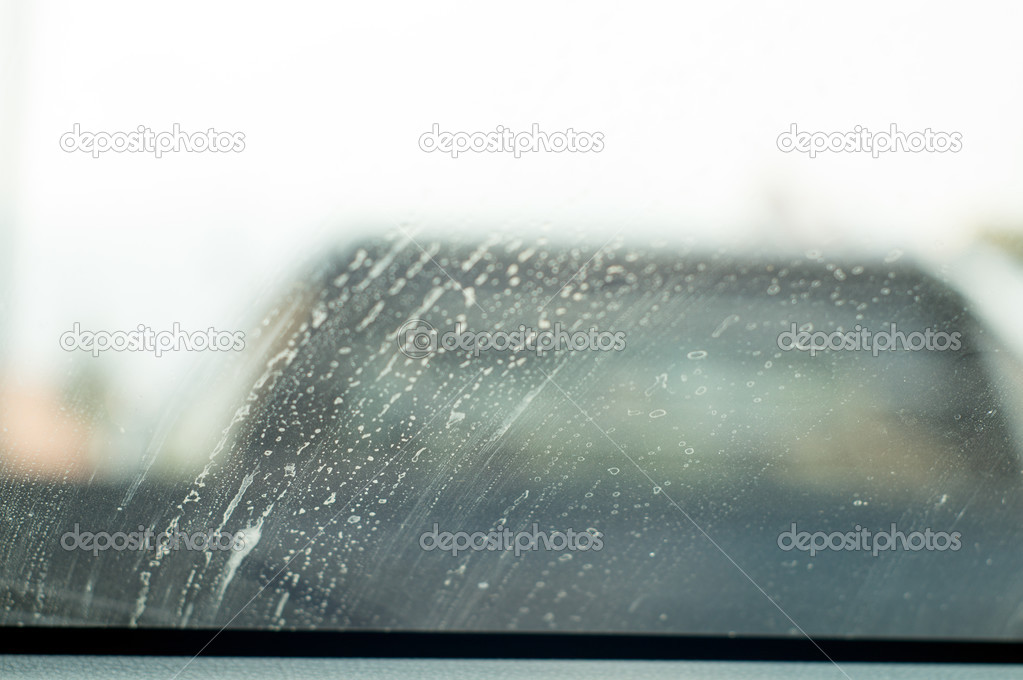 Dirty mirror car windshield with wiper