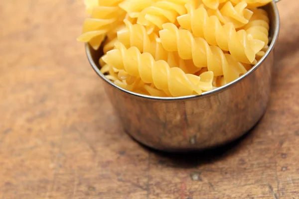 Pasta in measuring cup — Stock Photo, Image