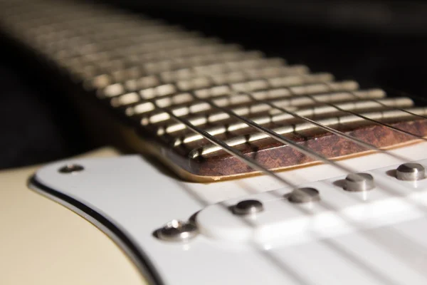 lighted guitar fretboard in a dark scenery