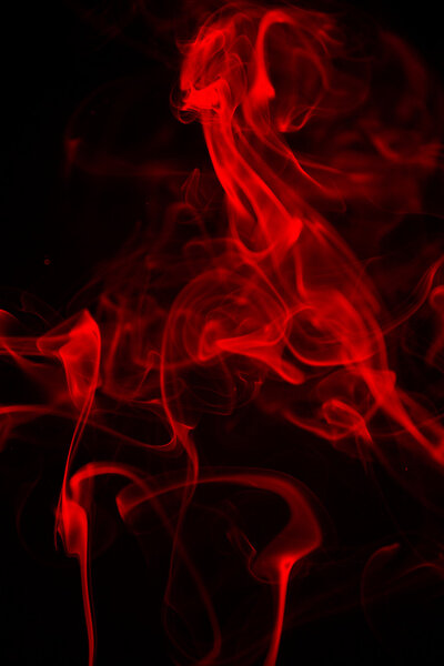 Red smoke form like a ghost on a black backgroun