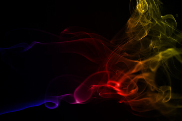 Mysterious smoke form with colour gradient on a black background