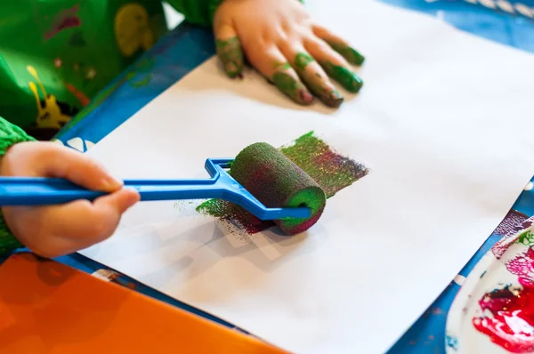 Child painting with roller — Stock Photo, Image