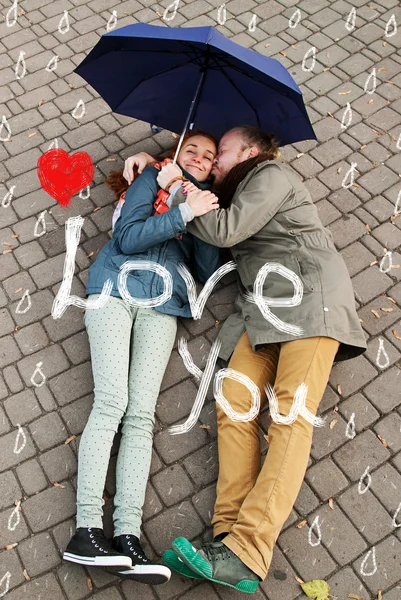 Love story under the painted rain. Man and woman in love. The girl is in love with his friend. — Stock Photo, Image