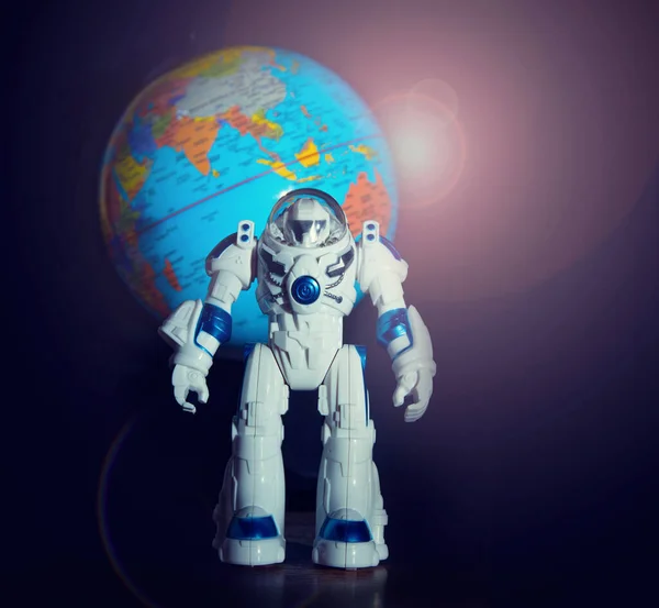 Spaceman toy on the background of the planet earth in the area of Australia, India and China. Space program concept.