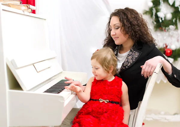 母亲和女儿玩白色钢琴 — 图库照片