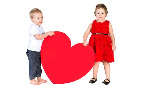 Children with huge heart made of red paper — Stock Photo, Image