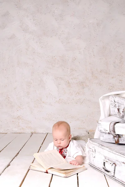 Chlapec na bílé malované podlahové — Stock fotografie