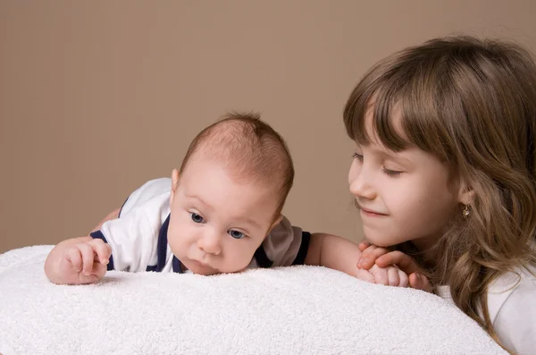 Older sister look her baby brother — Stock Photo, Image