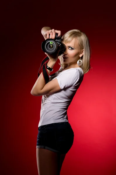Elegant sexy girl holding a camera — Stock Photo, Image