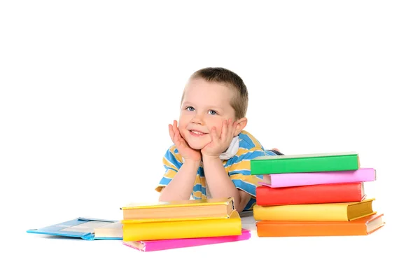 Pojke med högar av böcker — Stockfoto