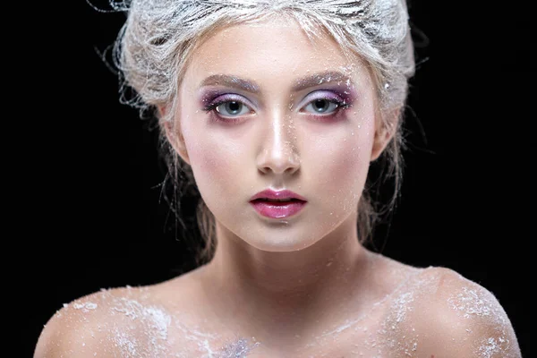 Winter Beauty Woman in clothes made of frozen flowers covered with frost, with snow on her face and shoulders. Christmas Girl Makeup. Make-up the snow Queen. Isolated on a black background. Close-up. — Stock Photo, Image